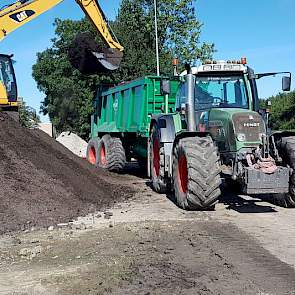 Medewerkers van loonbedrijf Van het Goor uit Elburg laden de wagens met een kraan en rijden de compost vervolgens uit.